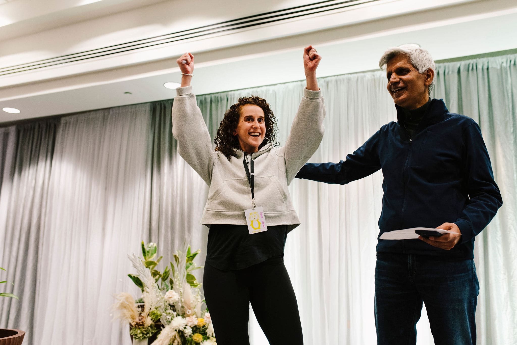 Hitendra Wadhwa smiling and engaging with a participant on stage at Lululemon event