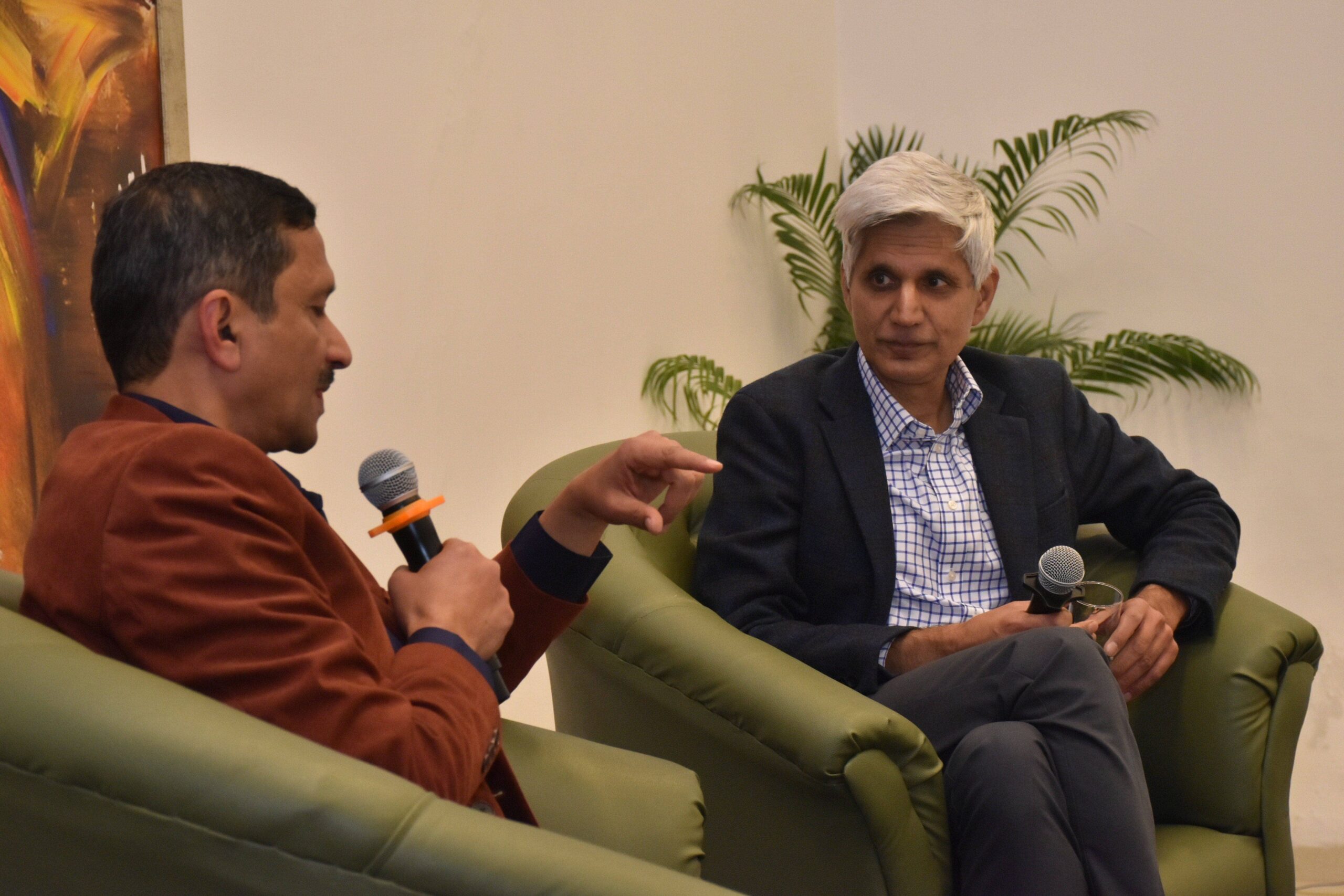 Hitendra Wadhwa in conversation with a man on green sofa at Chandigarh Talk