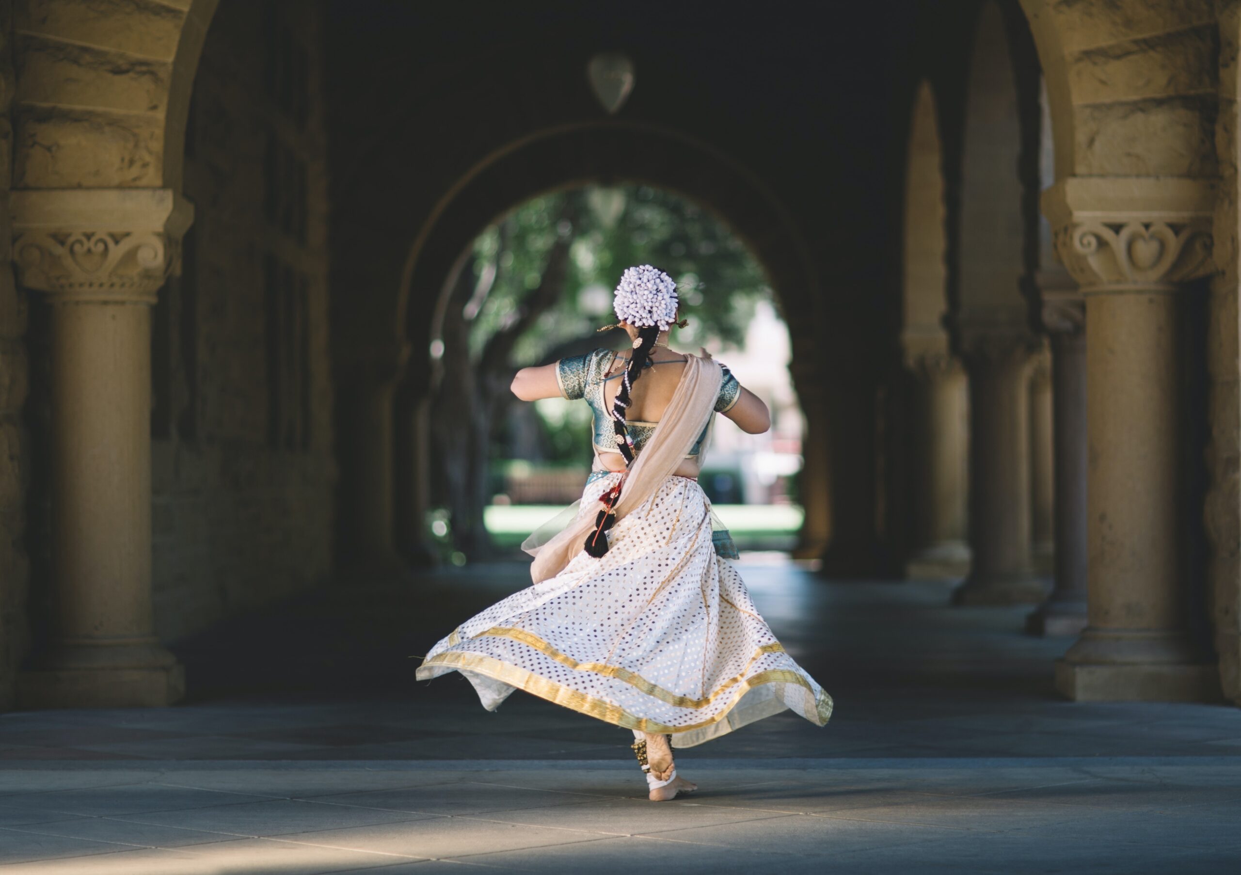 a girl in beautiful dress dancing and reminding expanding happiness horizons beyond your own culture.