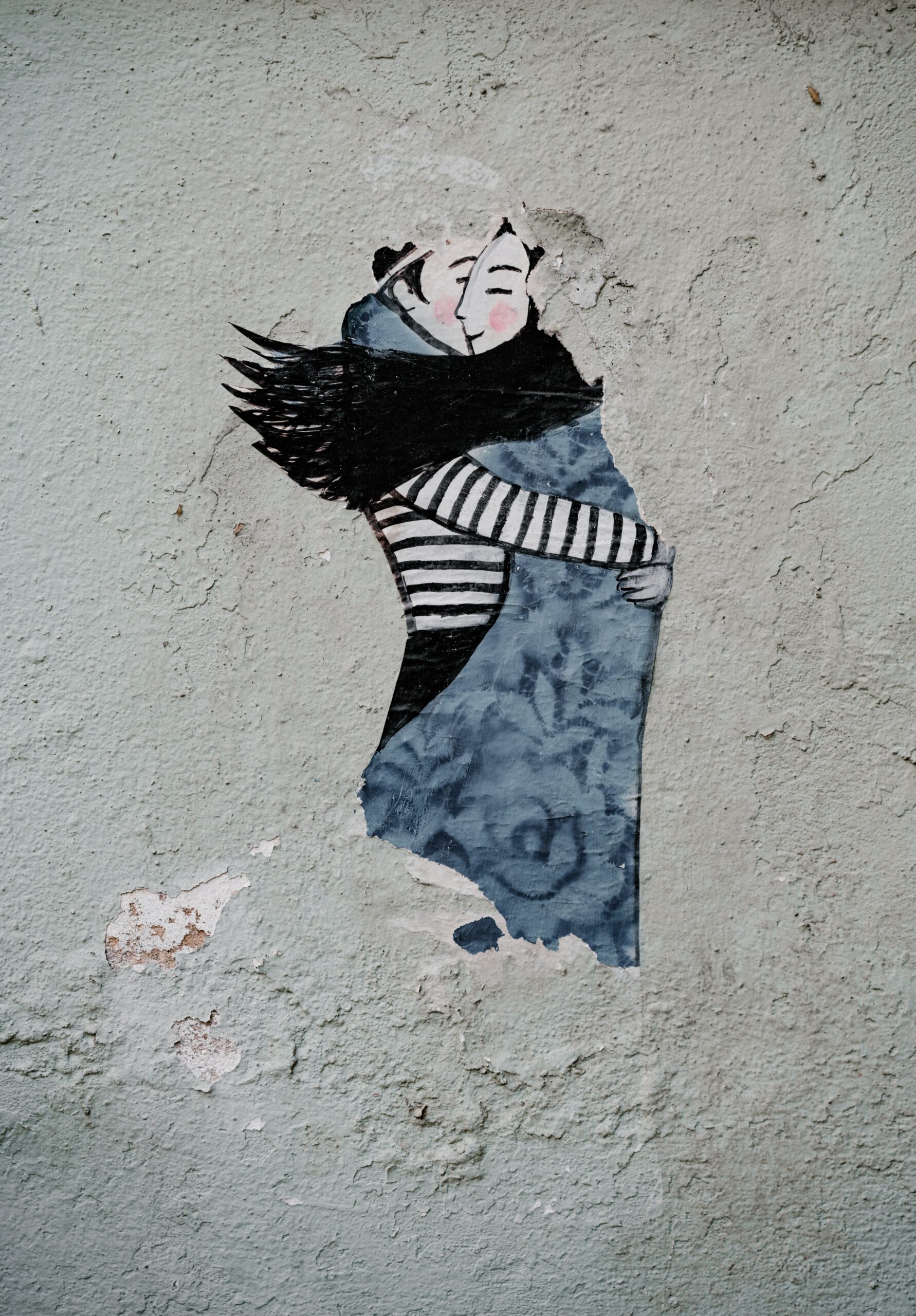drawing on the wall of a boy and a girl hugging each other indicating care and empathy.