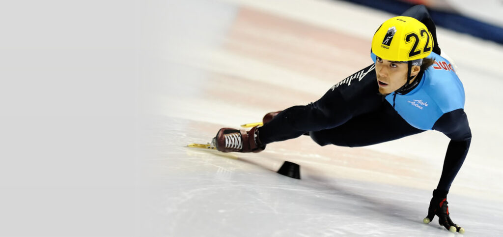 America's celebrated short-track speed skater, Apolo Ohno, at one of his games, gliding past obstacles with grit and determination