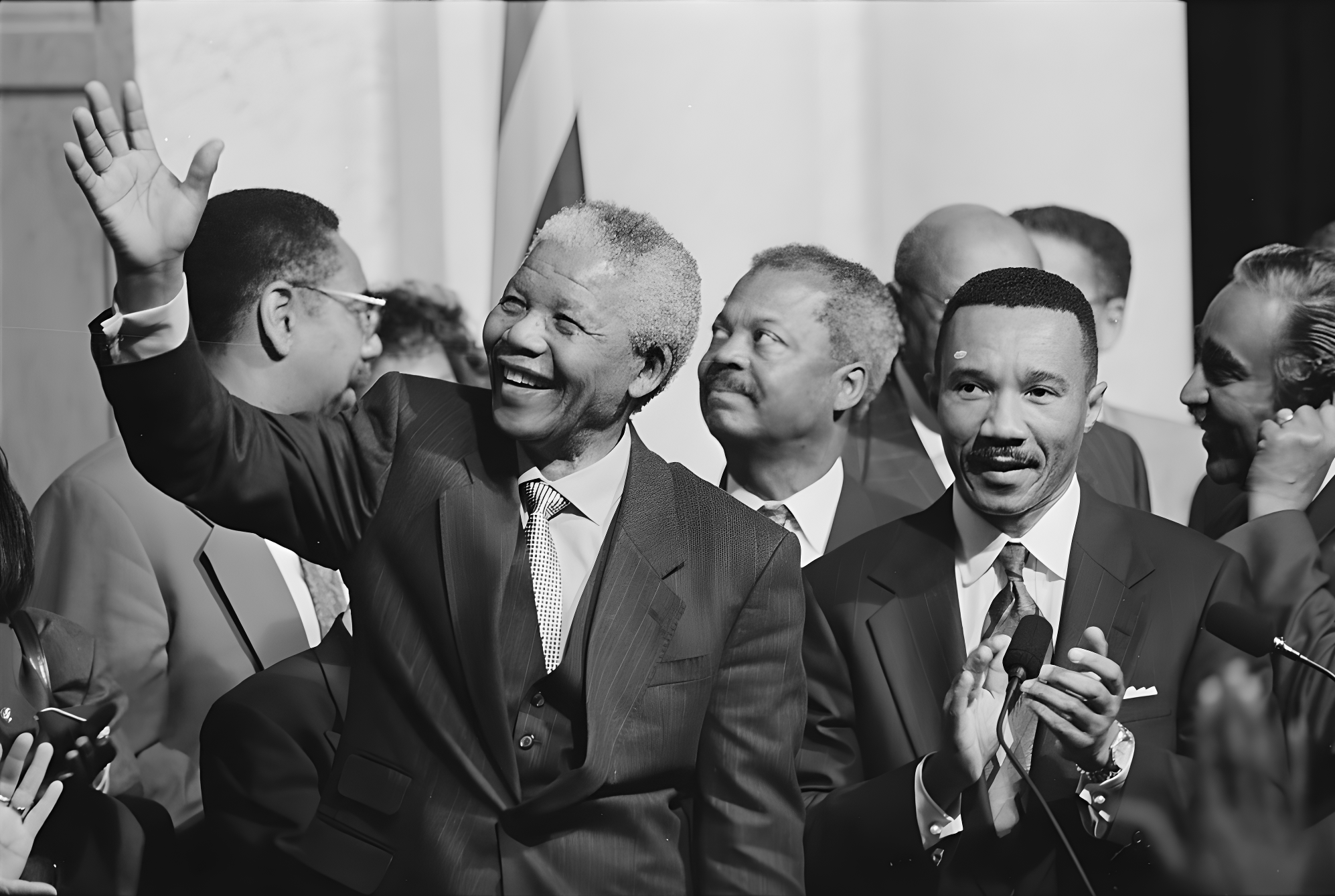 a group of people with Nelson Mandela at front standing on the stage indicating great leadership.