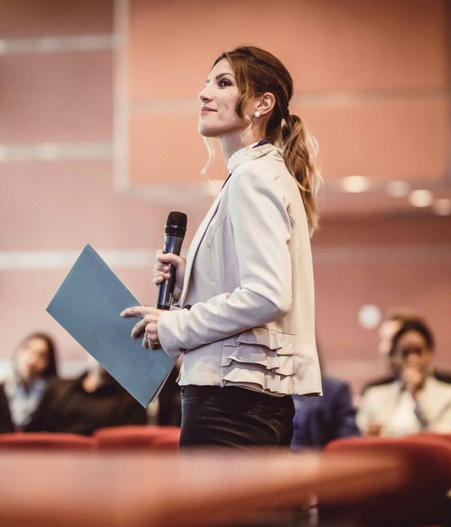 A woman giving a presentation in a conference